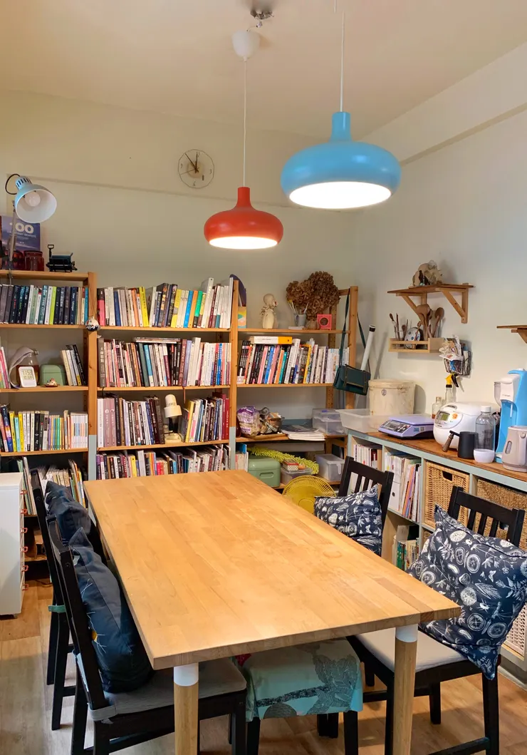 櫃子選用IKEA的組合式層架，並延續家中牆壁的淺藍色主視覺，在櫃子及腰處塗上漆。圓潤的燈具和時鐘帶點童趣，如同好好小姐的內心世界，充滿對生活的好奇心。另外，他分享家裡使用整捲式地板，施作簡單，踩上去的感覺很舒服，且因為沒有縫隙，整片直接貼在地上，打翻水也不用擔心滲下去，