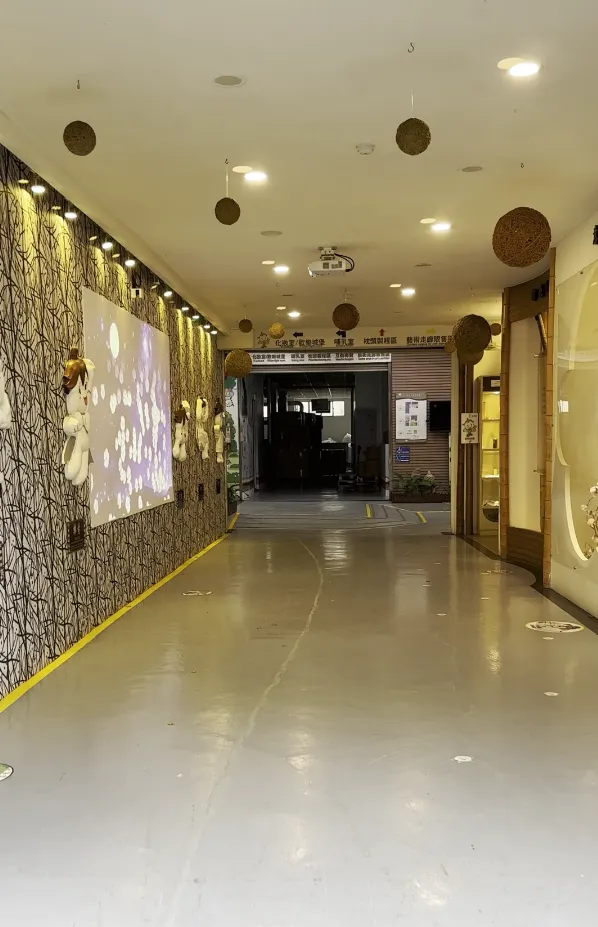 走道旁的大螢幕飄著一朵朵棉花，觸控面板讓一堆小孩還沒進門就開始拍棉花XDD