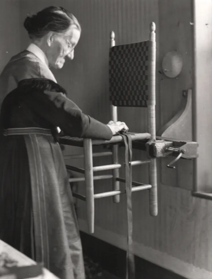 Sister Sarah Collins weaving a chair seat in her workroom, c. 1935-36 Collection of Hancock Shaker Village, photo: Noel Vincentini