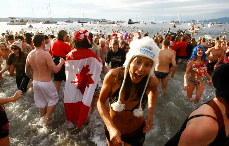 Revelers run into English Bay during the annual New Year's Day Polar Bear Swim in Vancouver.