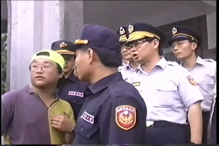 1994花蓮反水泥大遊行。我與警方協商的照片。我（左）。花蓮警分局長張琪（右後）。台視記者：楊咨誼