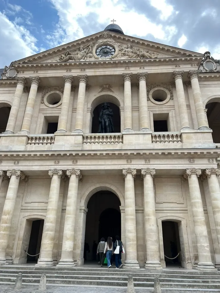 There is a statue of Napoleon on the second floor balcony