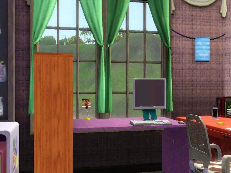 床的旁邊是電腦桌，對著一片風景。