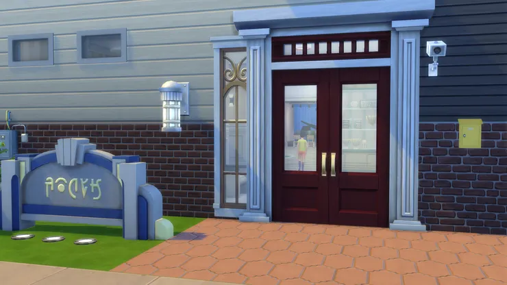 我覺得校門不能隨便，因為這是給人的第一印象。我特意選了跟牆身磚頭一樣的酒紅色。