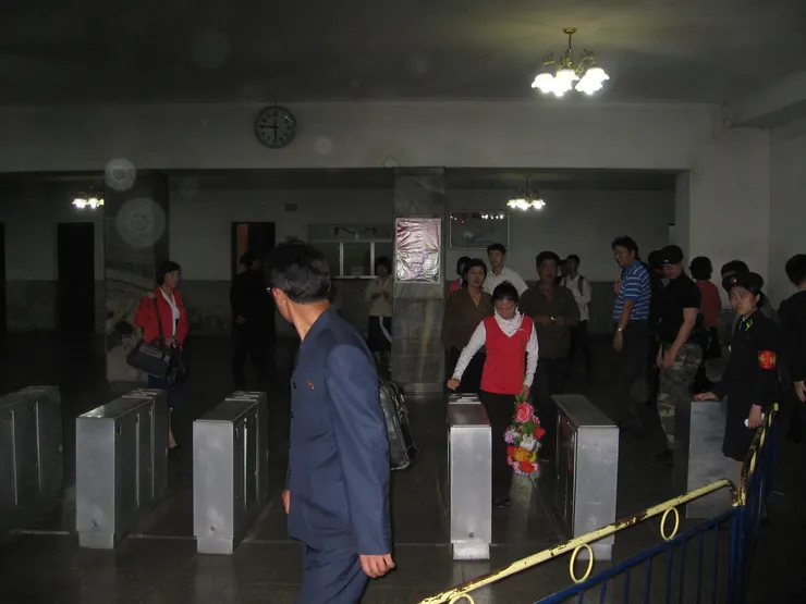 平壤地鐵出入口及服務員(多漂亮的閃鏡頭啊XD。另外，在此向北韓民眾致歉，為了搶拍，頗沒禮貌，還請海涵！)。