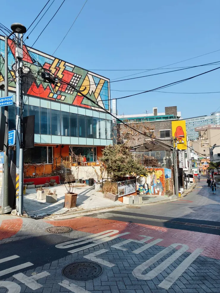 從上坡往下回頭看，民宿在左手邊下坡道路上，陽光明媚。