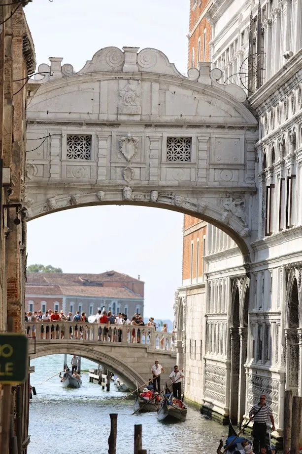 圖文不符之威尼斯嘆息橋；橋右方建物是總督府，左側是監獄。站了許多人的是麥桿橋（Ponte della Paglia），更後方的是聖喬治馬焦雷教堂（Abbazia di San Giorgio Maggiore）。