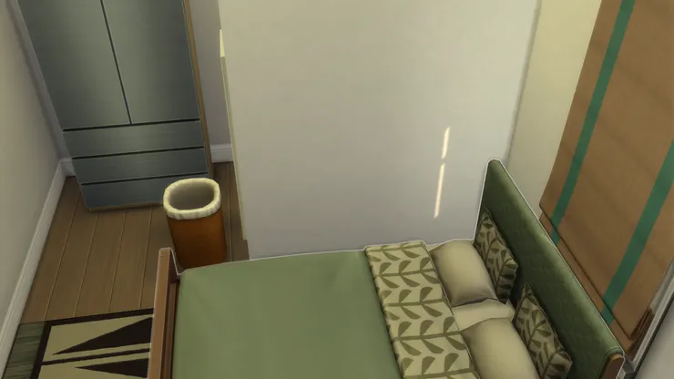 在遊戲裏,本來這房間的床是向直擺放,床頭便是靠在這面牆上,可是我不喜歡,覺得地方不實用,便把床的方向改了。