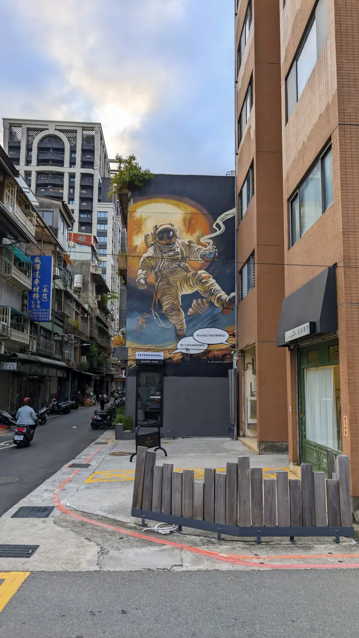 太空人的彩繪與左側的老店招牌有種不協調的違合感