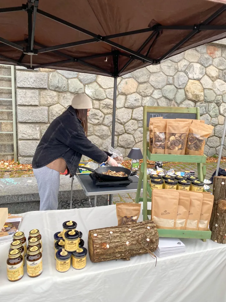 ▲賣些乾香菇、香菇抹醬之外，現場也擺出栽培香菇的原木菌木段，還炒起香菇，可能是提供試吃或現點現做。