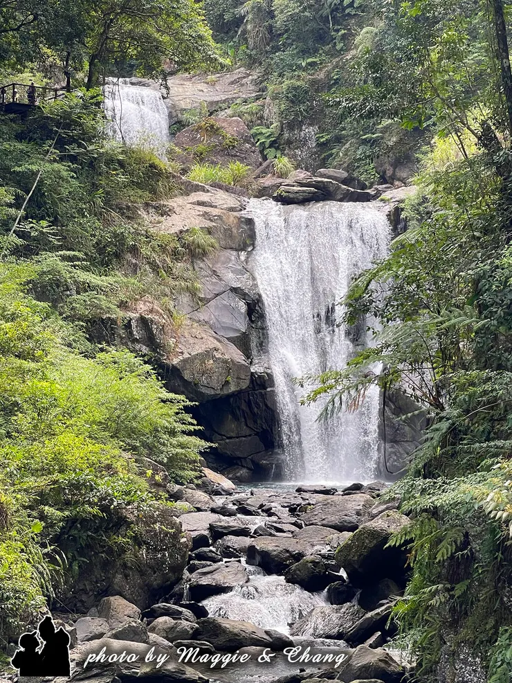 走在山林間，耳邊先聽見轟隆的水聲，抬頭一望，驚見兩層壯觀的瀑布傾瀉而下。水花在陽光下閃爍，如銀白絲帶般飛舞，氣勢磅礡卻又帶著沁涼的清新感，讓人忍不住停下腳步，靜靜感受大自然的震撼與美麗。