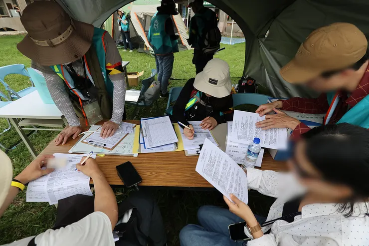 收容組的行政作業包括收容居民的基本消毒安檢、資料登錄、生活公約說明、領取生活物資、帶往安置區進行生活環境介紹與休息；收容組另備有英文版文件供外籍人士閱讀