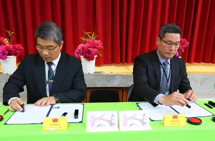 澎湖監獄典獄長曾至勳（左）與澎湖郵局局長蔡南德（右）進行合作備忘錄簽署儀式。(圖／澎湖郵局提供)