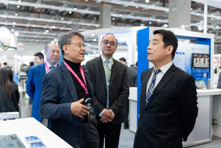 交通部伍勝園次長（右）聆聽陽明交大黃經堯產創長（左）介紹展出亮點。（圖/陽明交大提供）