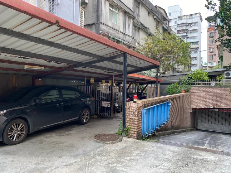 溪水穿過社區大樓，往興隆路二段220巷的方向流去