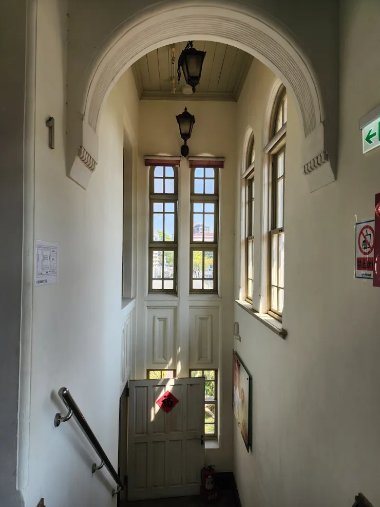 爬完樓梯回望，挑高的天花板與長窗。