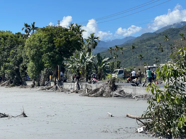 志工在大太陽下進入水溝內