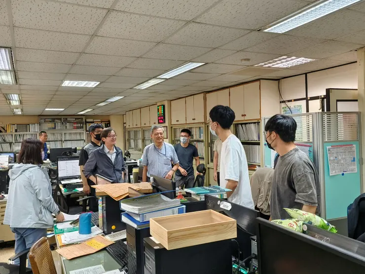 【辭行巡禮─儀一。部份同仁一早已赴現場一切如常,埋首書案的但起立道喜滿臉笑容。】