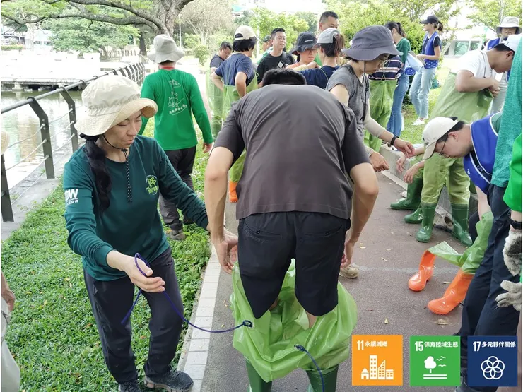 準備「『扛』島下水」前,有下水經驗的荒野夥伴幫忙企業夥伴體驗第一次穿青蛙裝的奇特經驗