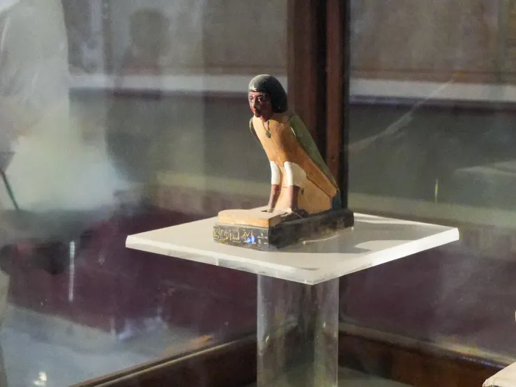 Small figurine symbolising the human soul, with AI tool used to erase visible hands.