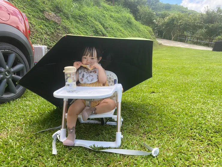 還小的皮梅可以用傘遮陽，自己一個人乖乖地吃吐司