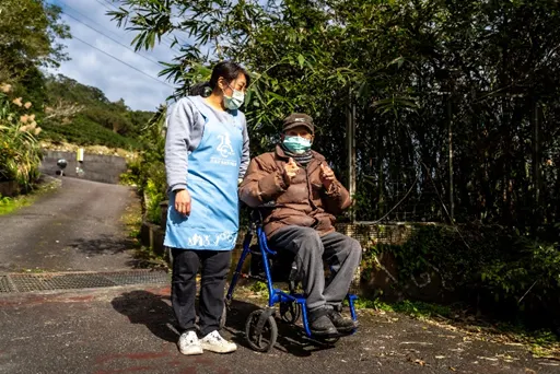 天氣晴朗，居服員劉素伶陪伴爺爺外出曬太陽、聊天。