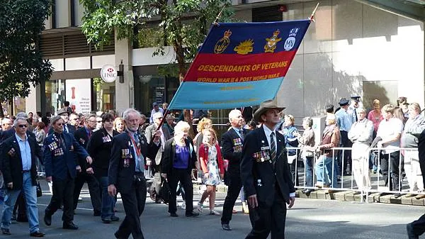 參與遊行的家屬後代，別上先人的勳章，緬懷他們的貢獻，展現榮耀