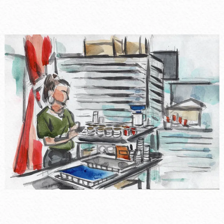 將咖啡磨粉蓋好後，待命中的工作人員。