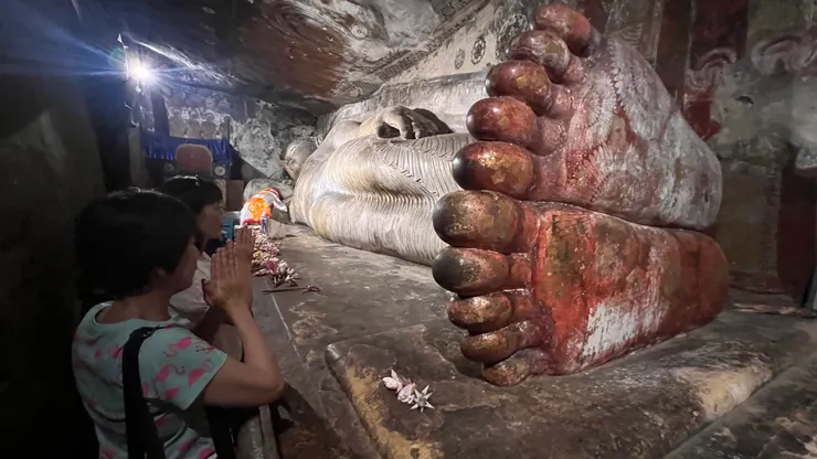 雙腳腳趾呈一前一後涅槃佛，腳底有蓮花圖案。