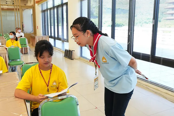 Martha helping campers with their English as a summer camp leader