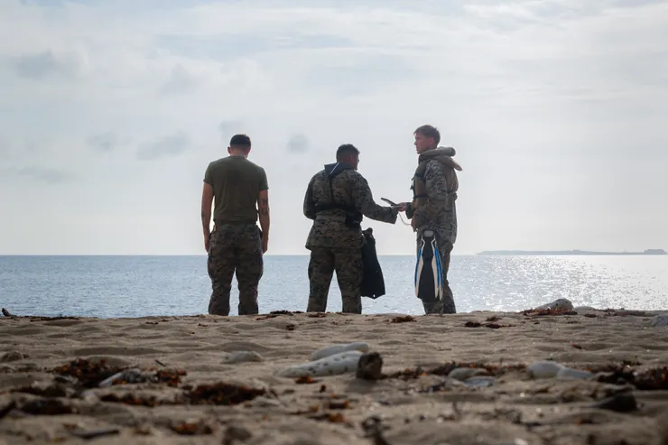 U.S. Marines with 9th Engineer Support Battalion, 3rd Marine Logistics Group and 12th Littoral Logistics Battalion, 12th Marine Littoral Regiment, 3d Marine Division, assess the area for a beach landing site survey as part of Resolute Dragon 25 at Camp Courtney, Okinawa Japan, Sept. 11, 2025. (U.S. Marine Corps photo by Cpl. Giovanni Navarrette via DVIDS)