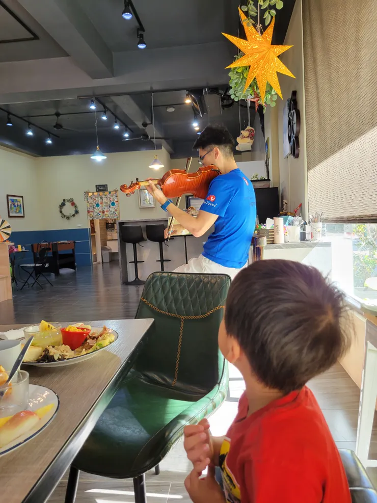 民宿老闆在早餐時段演奏小提琴