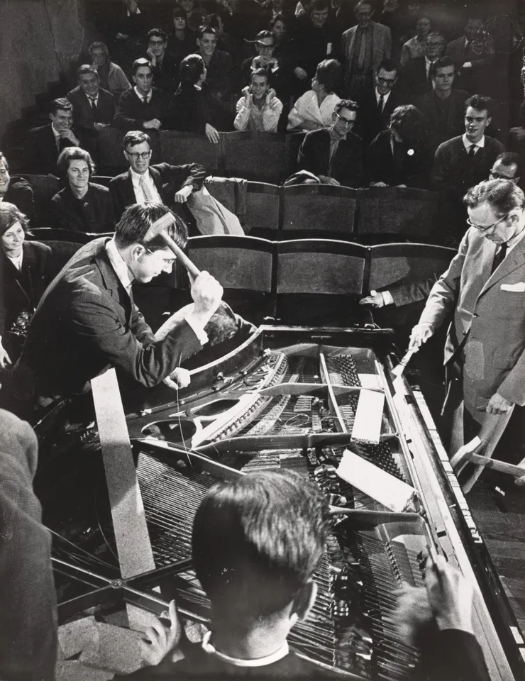 Philip Corner's Piano Activities, performed by Philip Corner, George Maciunas, Emmett Williams, Benjamin Patterson, Dick Higgins, and Alison Knowles during Fluxus Internationale Festpiele Neuester Musik, Hörsaal des Städtischen Museums, Wiesbaden, Germany, September 1, 1962.