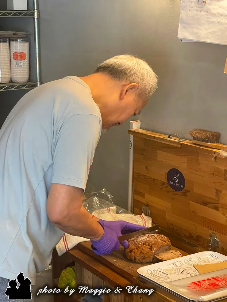 老闆認真呵護小心地切著精心製造的麵包