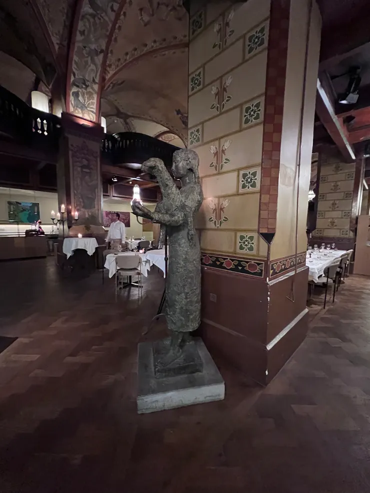 餐廳的角落，抱著羊的少女雕像