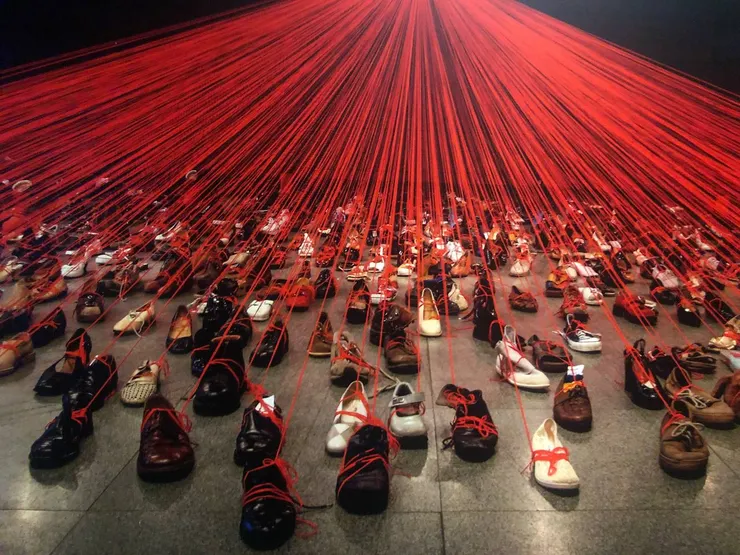 〈來自DNA的對話〉，2004，裝置(舊鞋、紅色毛線)，日本藝術與科技博物館，克拉科夫，波蘭；2019，數位輸出，照片攝於台北市立美館展場。