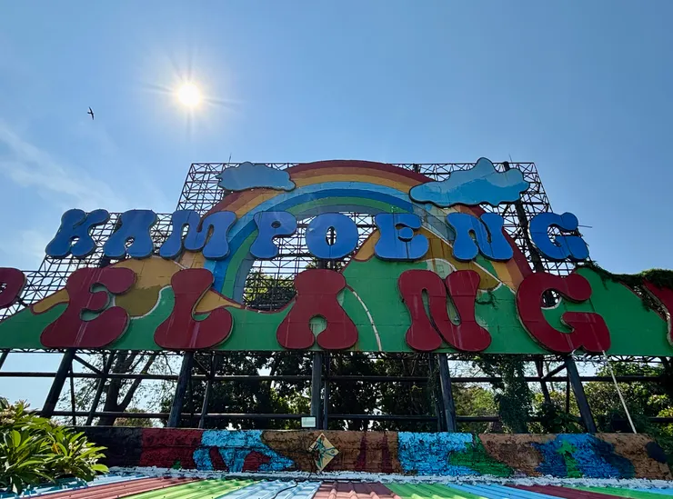 彩虹村大大的招牌立在山丘上