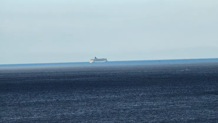 遠方是早我們一步離開基隆港的挪威郵輪奮進號!